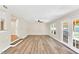 Open living room featuring hardwood floors, ceiling fan and access to backyard at 105 N 11Th St, Erwin, NC 28339