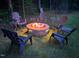 Cozy backyard fire pit surrounded by chairs, perfect for relaxing evenings and gatherings at 110 Pebble Creek Dr, Franklinton, NC 27525
