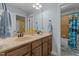 This bathroom features a double sink vanity with a shower tub combo with ample lighting at 110 Pebble Creek Dr, Franklinton, NC 27525