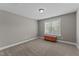Simple bedroom design with neutral carpet and gray walls with a window with blinds for natural light at 110 Pebble Creek Dr, Franklinton, NC 27525