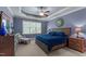 This bedroom offers a tray ceiling, a ceiling fan, and a large window for plenty of natural light at 110 Pebble Creek Dr, Franklinton, NC 27525
