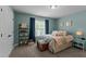 Comfortable bedroom with a large window, dark-blue curtains, a ceiling fan, and neutral walls at 110 Pebble Creek Dr, Franklinton, NC 27525
