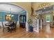 Elegant dining room with hardwood floors, chandelier, and a built-in cabinet, flowing into a living area with a fireplace at 110 Pebble Creek Dr, Franklinton, NC 27525
