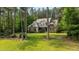Charming two-story home with a stone and gray facade, complemented by a lush, green lawn at 110 Pebble Creek Dr, Franklinton, NC 27525