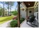 Inviting front porch with rocking chairs and hanging flower baskets, perfect for relaxing at 110 Pebble Creek Dr, Franklinton, NC 27525