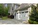 Spacious two-car garage featuring white doors, and mature landscaping at 110 Pebble Creek Dr, Franklinton, NC 27525