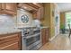 Gourmet kitchen features stainless steel range, granite countertops, and custom backsplash at 110 Pebble Creek Dr, Franklinton, NC 27525
