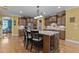 Well-equipped kitchen featuring a granite island with seating, custom cabinets, stainless steel appliances, and modern lighting at 110 Pebble Creek Dr, Franklinton, NC 27525