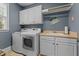 Well-equipped laundry room features modern washer and dryer, and plenty of storage at 110 Pebble Creek Dr, Franklinton, NC 27525