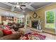 Spacious living room with coffered ceilings, a cozy fireplace, hardwood floors, and open access to the kitchen and dining area at 110 Pebble Creek Dr, Franklinton, NC 27525