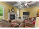Comfortable living room with coffered ceilings, a stylish fireplace, a large TV, and plush seating for relaxation at 110 Pebble Creek Dr, Franklinton, NC 27525