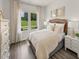 Inviting bedroom with natural light, comfortable bedding, stylish nightstands, and elegant decor at 1100 Landen Creek Ln, Zebulon, NC 27597