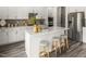 Bright, modern kitchen with white cabinets, stainless steel appliances, and a center island with seating at 1100 Landen Creek Ln, Zebulon, NC 27597
