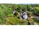 Aerial view of a house with a big yard surrounded by lush trees in a suburban community at 1114 Balmoral Dr, Cary, NC 27511