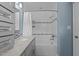 Beautiful blue bathroom featuring a shower and tub combination with sleek white tile and granite countertops at 1114 Balmoral Dr, Cary, NC 27511