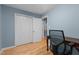 Home office with hardwood floor, desk, and closet at 1114 Balmoral Dr, Cary, NC 27511