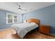 Bedroom features a ceiling fan, a window, and wood floors at 1114 Balmoral Dr, Cary, NC 27511