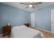Cozy bedroom featuring a ceiling fan, hardwood flooring, and a window at 1114 Balmoral Dr, Cary, NC 27511