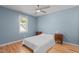 Cozy bedroom featuring a ceiling fan, hardwood flooring, and a window at 1114 Balmoral Dr, Cary, NC 27511
