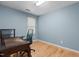 Home office with a hardwood floor, desk, and natural light streaming through the window at 1114 Balmoral Dr, Cary, NC 27511