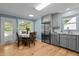 Eat-in kitchen features stainless appliances, gray cabinetry, and a sunny breakfast nook at 1114 Balmoral Dr, Cary, NC 27511