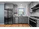 Updated kitchen featuring stainless appliances, gray cabinetry and tile backsplash at 1114 Balmoral Dr, Cary, NC 27511