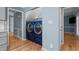 Laundry room features blue washer and dryer and storage shelves at 1114 Balmoral Dr, Cary, NC 27511