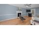 Living room features hardwood floors, ceiling fan, fireplace, and serene, paint colors at 1114 Balmoral Dr, Cary, NC 27511
