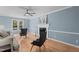 Living room featuring a ceiling fan, fireplace, and hardwood floors at 1114 Balmoral Dr, Cary, NC 27511