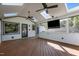 Screened porch featuring a wood floor, skylights, a ceiling fan, and views of the backyard at 1114 Balmoral Dr, Cary, NC 27511