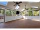 Screened porch featuring a wood floor, skylights, a ceiling fan, and views of the backyard at 1114 Balmoral Dr, Cary, NC 27511