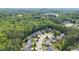 Overview of homes nestled amongst lush, vibrant green trees in the neighborhood at 114 Bell Tower Ct, Elon, NC 27244