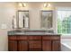 Bathroom featuring double sinks, granite counters, soaking tub, and bright natural light at 114 Bell Tower Ct, Elon, NC 27244