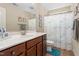 Bathroom with a wooden vanity, large mirror and shower with fish-themed curtain at 114 Bell Tower Ct, Elon, NC 27244