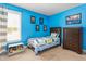 Bedroom with bright blue walls, wood furniture, and carpeted floors at 114 Bell Tower Ct, Elon, NC 27244