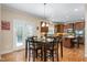 Cozy breakfast nook featuring wood table with seating, and a view of the kitchen and backyard at 114 Bell Tower Ct, Elon, NC 27244