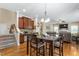 Kitchen dining area flowing to Gathering room. Featuring granite, wood cabinets and floors at 114 Bell Tower Ct, Elon, NC 27244