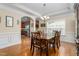 Formal dining room with hardwood floors, crown molding, and a view into the kitchen at 114 Bell Tower Ct, Elon, NC 27244