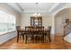 Traditional dining room with wood table, wood floors, a buffet and a decorative light fixture at 114 Bell Tower Ct, Elon, NC 27244