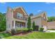 Two-story home with stone and siding, featuring a front porch and landscaped yard at 114 Bell Tower Ct, Elon, NC 27244