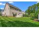 Back exterior of the home with a spacious yard, deck and storage building at 114 Bell Tower Ct, Elon, NC 27244
