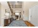 Grand foyer with hardwood floors, staircase, and view into dining room and second-story landing at 114 Bell Tower Ct, Elon, NC 27244