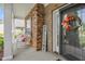 Charming front porch with rocking chairs, stone accents, and a decorated front door at 114 Bell Tower Ct, Elon, NC 27244