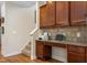 A home office featuring built in desk, granite countertop, tile backsplash and wood cabinets at 114 Bell Tower Ct, Elon, NC 27244