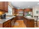 Large kitchen with granite countertops, tile backsplash, stainless steel appliances, and wood cabinets at 114 Bell Tower Ct, Elon, NC 27244