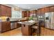 Well-equipped kitchen with granite counters, tile backsplash, center island, and stainless steel appliances at 114 Bell Tower Ct, Elon, NC 27244