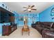Large living room with expansive couch, TV and university-themed decorations at 114 Bell Tower Ct, Elon, NC 27244