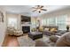Relaxing living room featuring a fireplace, comfortable seating, natural light, and a ceiling fan at 114 Bell Tower Ct, Elon, NC 27244