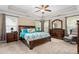 Spacious main bedroom with a ceiling fan, sitting area, and large windows for plenty of natural light at 114 Bell Tower Ct, Elon, NC 27244
