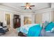 This large main bedroom includes a ceiling fan, ensuite bath, and upstairs hallway access at 114 Bell Tower Ct, Elon, NC 27244